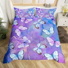 a bed with purple and blue butterflies on it