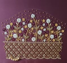 an embroidered piece with flowers and pearls on purple fabric, hanging from a wall in the shape of a basket