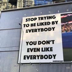 a sign on the side of a building that says stop trying to be liked by everybody you don't even like everybody