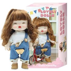 two dolls are standing next to each other in front of a box with the same image on it