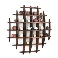 a wooden shelf with cups and vases on it's sides, hanging from the wall