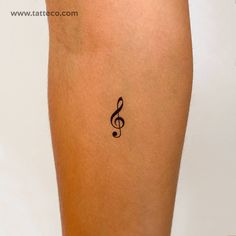 a tattoo on the leg of a woman with musical notes