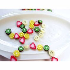 a white plate topped with fruit and veggies on top of watermelon slices