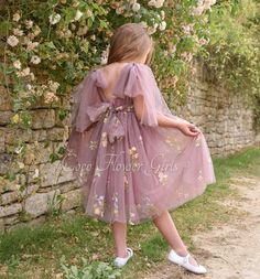 We know this is to be a sure best seller! Our newest style, and in a variety of beautiful colours.   The smoky heather lining has an embroidered tulle over lay bodice and skirt with pretty tie bows to the shoulders.  The pretty embroidered floral pattern over the top layer gives the skirt added fullness and makes the dress just perfect for flower girls. Available in ages 6 months to 12 years 10 Colours available, please search Embroidered dresses in the Shop Search bar, we also have baby rompers Boho Flower Girl Dress, Boho Flower Girl, Embroidered Dresses, Dress With Tulle, Boho Embroidery, Daisy Wedding, Girls Floral Dress, Tulle Bows, Baby Rompers