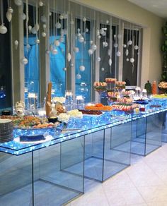 a buffet table with many different foods on it and decorations hanging from the windows behind