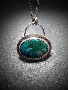 "Beautiful piece of gem silica chryscolla mounted in a handforged silver bezel.  Pendant measures 1.6\"(42.4mm) by 1.4\"(37.6mm) and weighs 0.4 oz. Pendant ships with a 20\"silver chain with lobster clasp and a gift box." Chrysocolla Gemstone Oval Pendant Jewelry, Silver Chrysocolla Necklace With Large Stone, Silver Oval Apatite Jewelry, Silver Chrysocolla Cabochon Jewelry, Round Chrysocolla Cabochon Jewelry, Handmade Oval Apatite Jewelry, Untreated Green Chrysocolla Jewelry, Gem Silica, Bezel Pendant