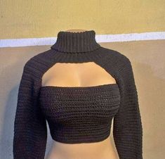 a mannequin wearing a black top with sleeves on it's chest and shoulder