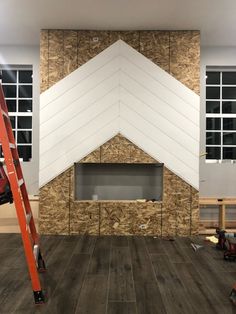 a room that is being remodeled with wood flooring and white paint on the walls