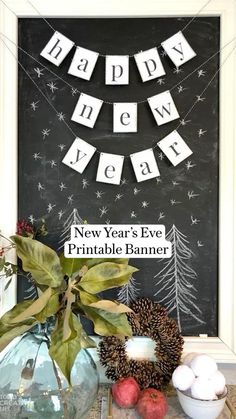 a chalkboard with happy new year written on it next to some decorations and apples