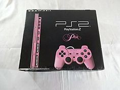 a pink playstation 2 game controller sitting on top of a white sheet