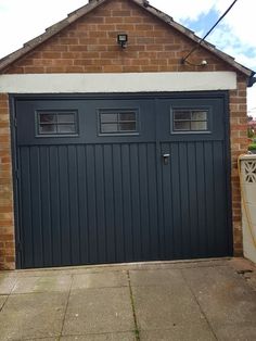 a garage door with two windows on the side of it