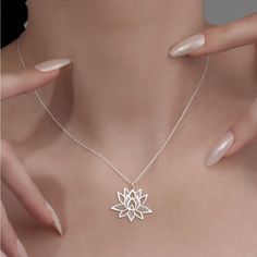 Elevate your style with the exquisite Lotus Flower Necklace from Sussex Home, a symbol of purity and grace. This sterling silver pendant is meticulously handcrafted in our workshop, ensuring each piece is a unique testament to artisan skill.

- Material: Sterling Silver
- Color: Silver
- Gender: Female
- Age Group: Adult

Ideal for bridesmaids, friends, or as a cherished gift to yourself, this necklace represents elegance and sophistication. To maintain its luster, avoid exposure to heat and har Silver Round Pendant Necklace For Meditation, White Spiritual Sterling Silver Necklace, Spiritual White Sterling Silver Necklace, Spiritual Flower Engraved Necklace, Elegant Nickel-free Jewelry For Meditation, Mother's Day Flower Pendant Necklace, Delicate Silver Charm Necklace With Flower, Silver Flower Necklace With Clavicle Chain, Spiritual Flower Pendant Necklace For Mother's Day