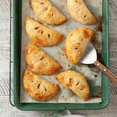 several pastries on a baking sheet with a spatula