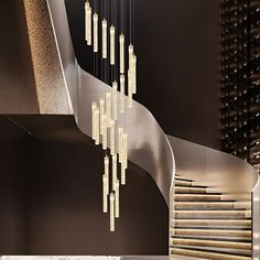 a spiral staircase with chandelier hanging from it's sides in a modern building