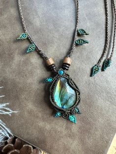 the necklace is adorned with blue beads and green glass bead accents, along with other jewelry items