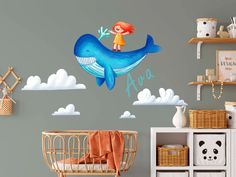 a child's room with a blue whale wall decal