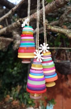 multicolored wooden ornaments hanging from a tree branch