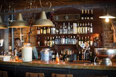 a bar with lots of bottles on the shelves