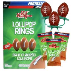 three football rings and two bags of fruit flavored lollipop rings in front of the package