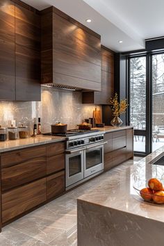 a modern kitchen with marble counter tops and stainless steel appliances, along with large windows