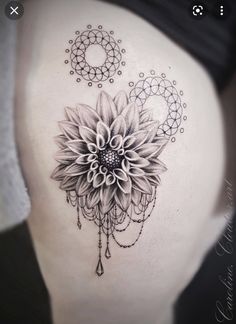 a woman's stomach with a flower tattoo on it