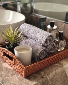 a tray with towels, candles and an air plant on it