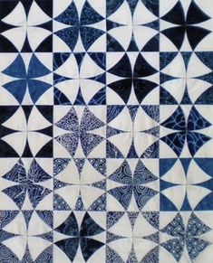 a blue and white quilt with many circular designs on the front, back and sides