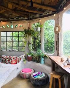 a living room filled with lots of furniture and plants on top of it's walls