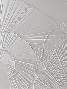 an abstract painting with white paint and lines on the paper, which has been cut into shapes