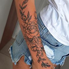 a woman with a flower tattoo on her arm