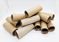 several rolled up brown paper tubes on a white surface