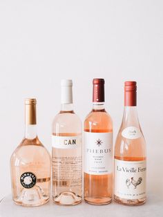 three bottles of wine sitting next to each other on top of a white countertop