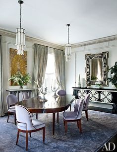 an elegant dining room with chandelier and chairs