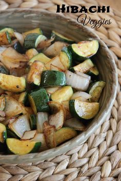 a bowl filled with vegetables sitting on top of a woven table cloth next to a basket