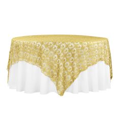 a gold and white tablecloth with flowers on the top, in front of a white background