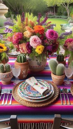 an outdoor table set with colorful flowers and place settings