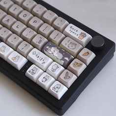 an old computer keyboard with cartoon characters on it's backlit keys and buttons