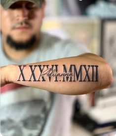 a man with a tattoo on his arm that reads xxxvim mmmi