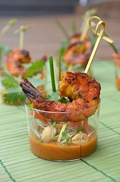 small glass cups filled with food on top of a table