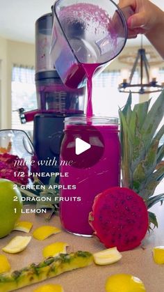 a person pouring juice into a blender with fruit on the table next to it