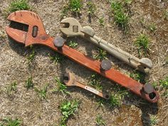 two tools are laying on the ground next to each other and one is made out of wood