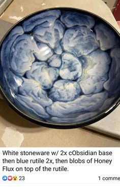 a blue and white bowl sitting on top of a counter next to a paper towel