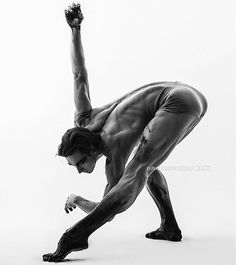 black and white photograph of a man doing a handstand