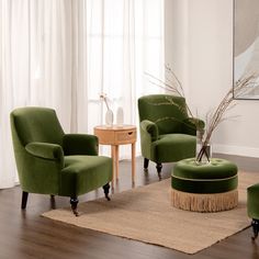 a living room with two green chairs and a round ottoman