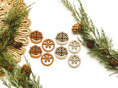 some pine cones and wooden buttons on a white surface