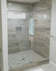 a walk in shower sitting inside of a bathroom