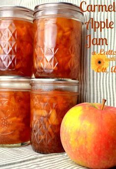 four jars filled with apple jam next to an apple on a striped tablecloth and the words, caramel apple jam