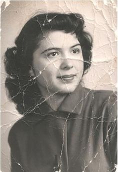 an old black and white photo of a woman's face with cracked glass on it