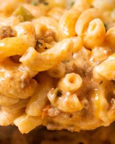 a spoon full of macaroni and cheese with meat