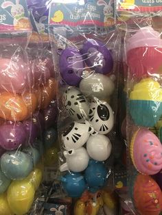 there are many different colored plastic eggs in this display case, and one is for sale at the store